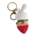 White hand-woven wire pendant with cartoon rabbit and strawberry design, shown with an integrated key.