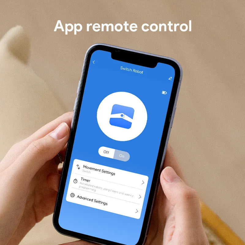 Small white Bluetooth rocker arm finger robot remote control on a grey surface.