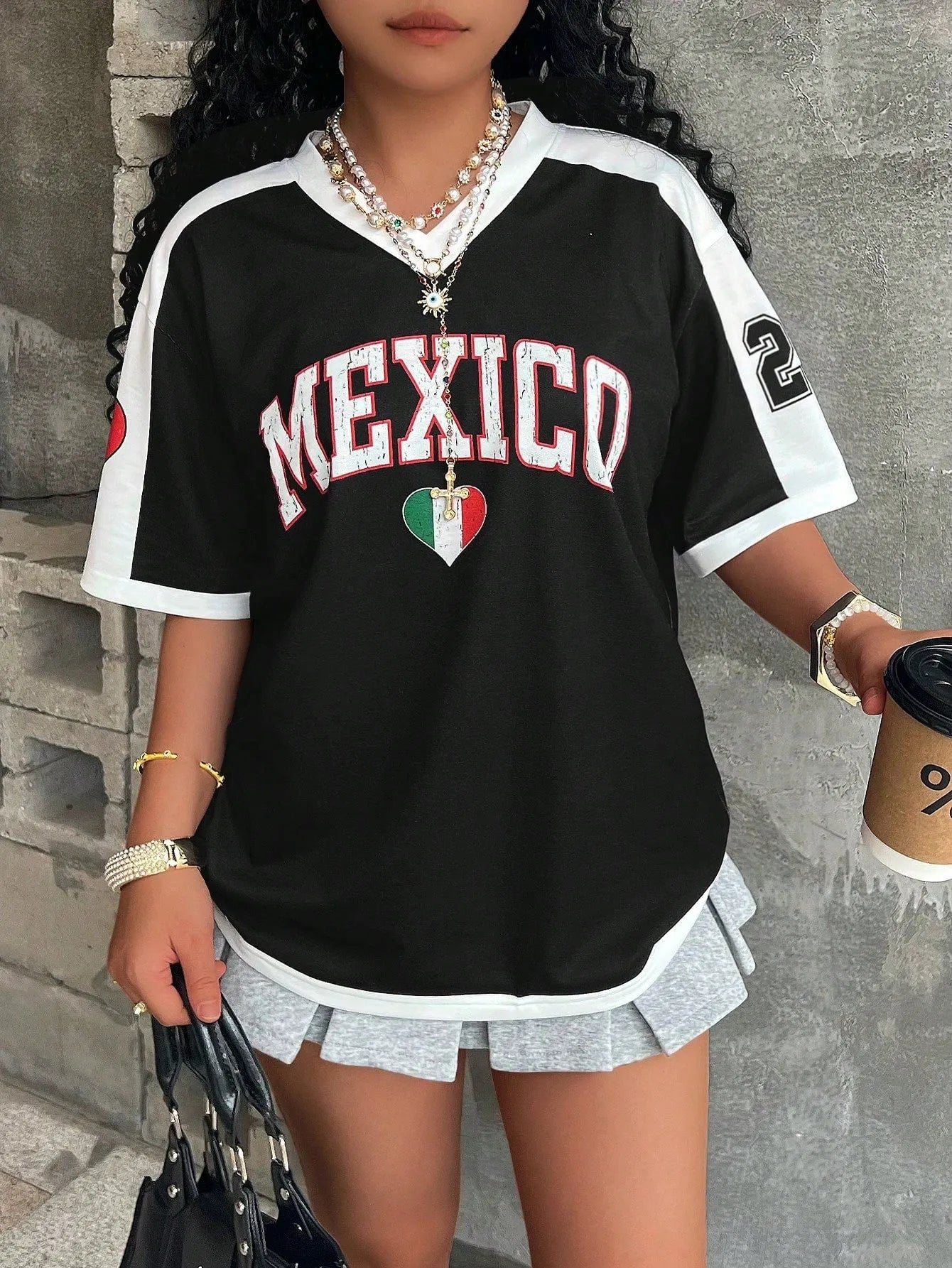Loose fit women's V-neck short sleeve t-shirt featuring 3D raised letter printing in a solid colour.