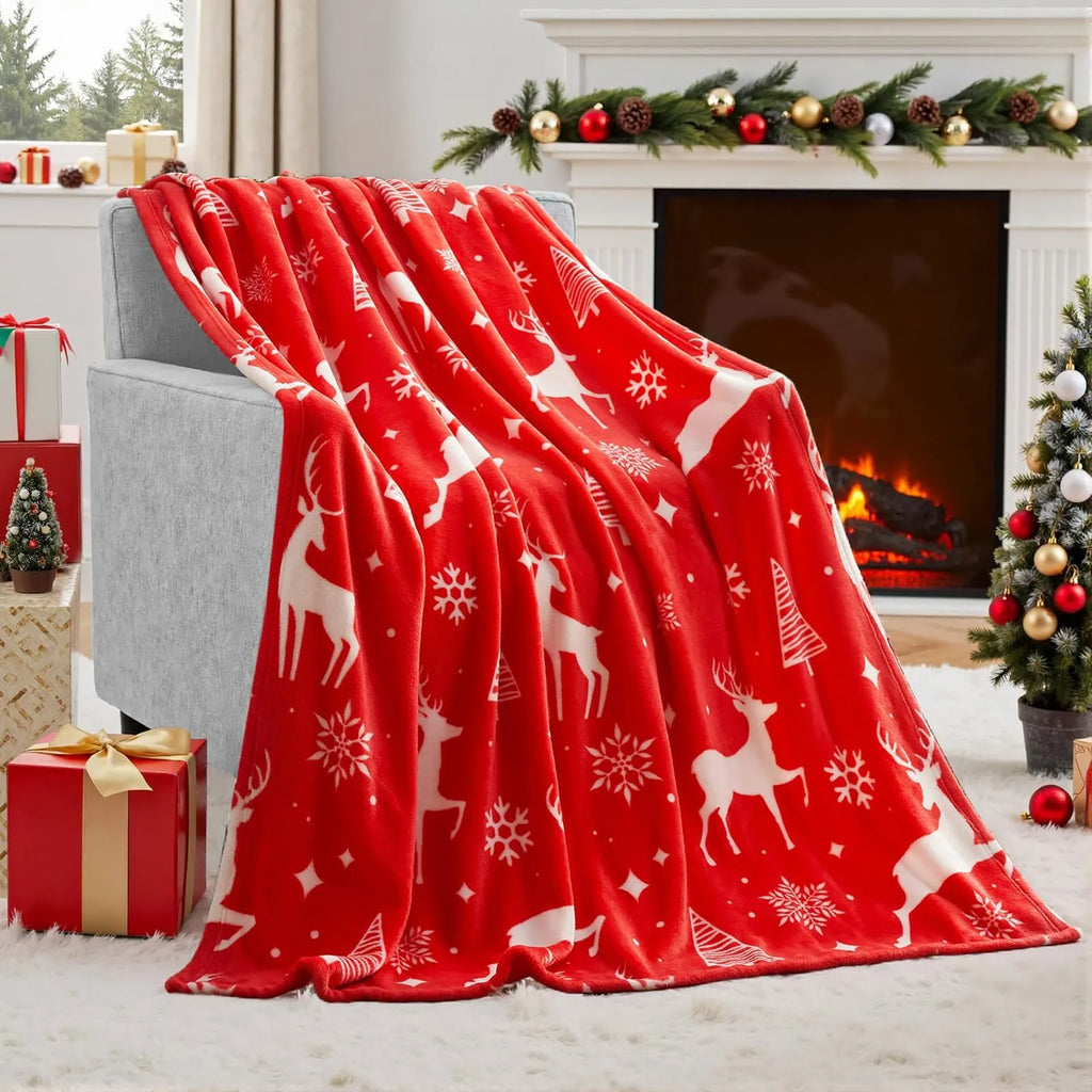 Soft red polyester flannel Christmas blanket draped over a sofa
