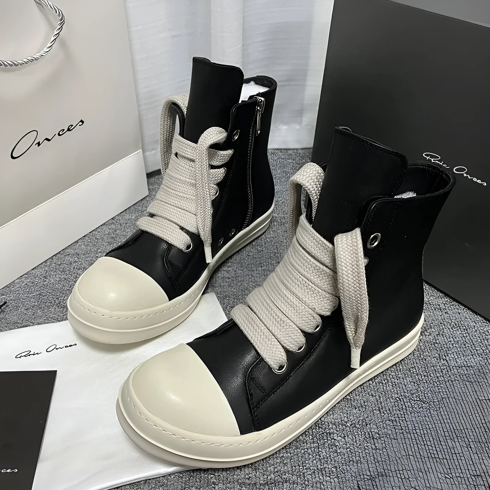 Black genuine leather high-top sneakers with side zipper and platform sole.