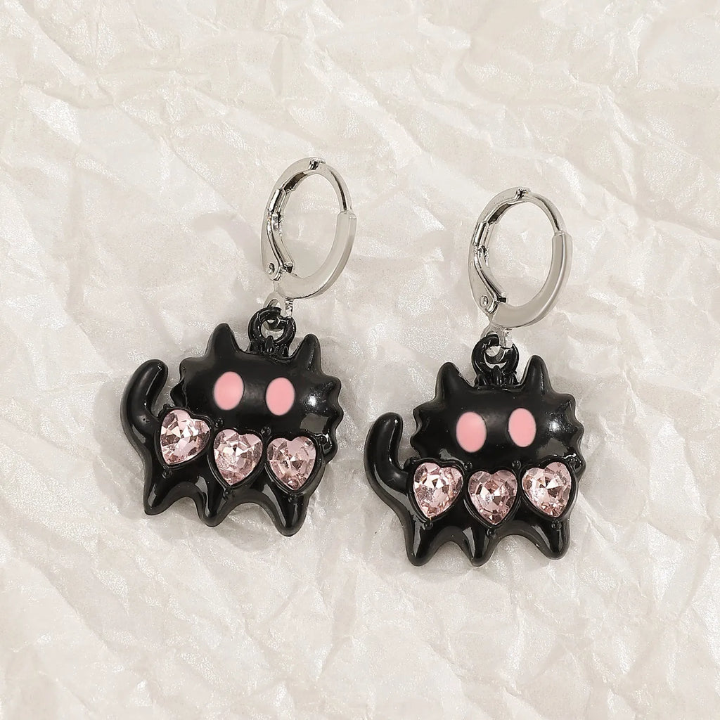 Women's classic alloy earrings with crystal detailing showing cross, heart, and cat designs in neutral white and silver colours