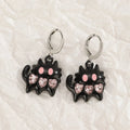 Women's classic alloy earrings with crystal detailing showing cross, heart, and cat designs in neutral white and silver colours