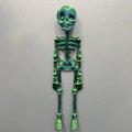 3D-printed white skull refrigerator magnet, 18cm tall, on a fridge door.