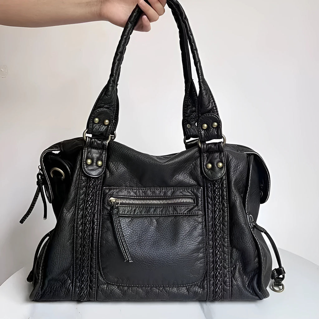 Women's European retro motorcycle messenger bag in bright black with golden edge showing weaving details and shoulder strap