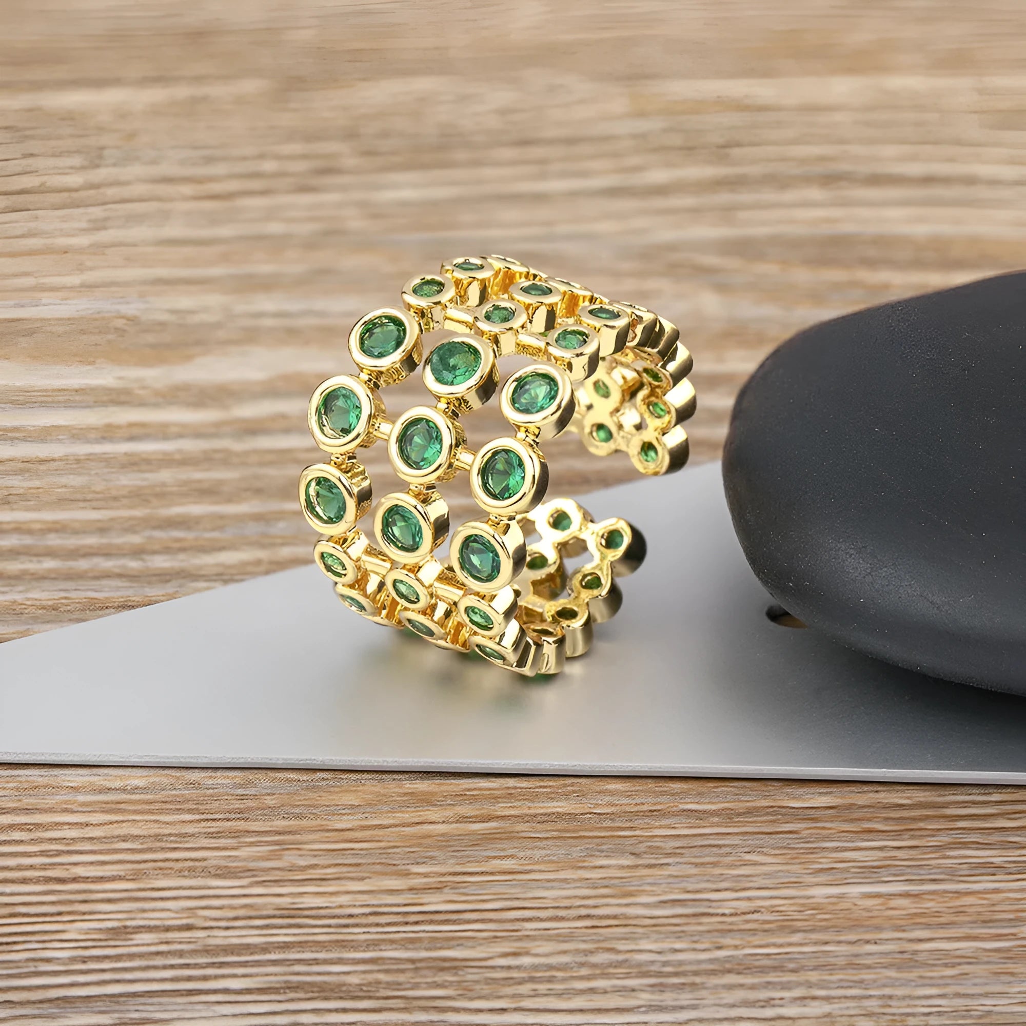 Copper ring with 18K gold plating and green zircon stones in wide band design