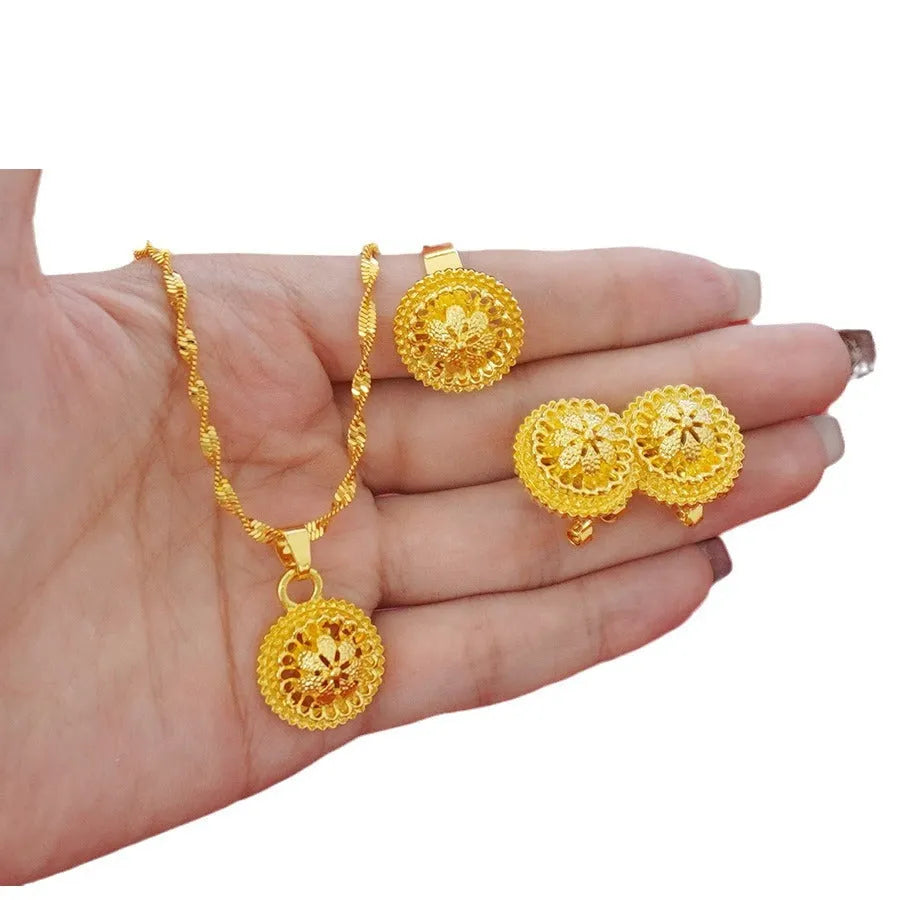 Gold-plated three-piece jewellery set with necklace, earrings, and ring featuring floral design patterns