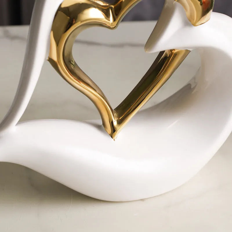 Modern white porcelain heart ornament with a geometric shape on a wooden surface.