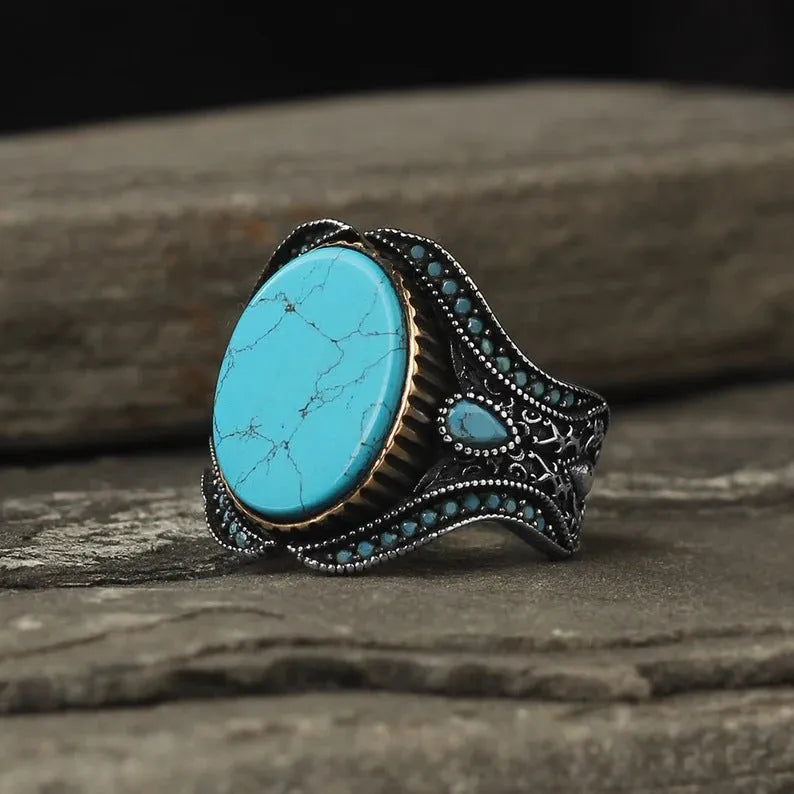Men's turquoise round ring with antique silver finish shown in UK size 10