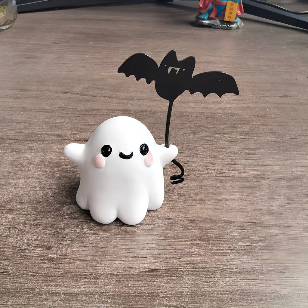 Small resin ghost walking dog statue with a bat, a Halloween decoration.