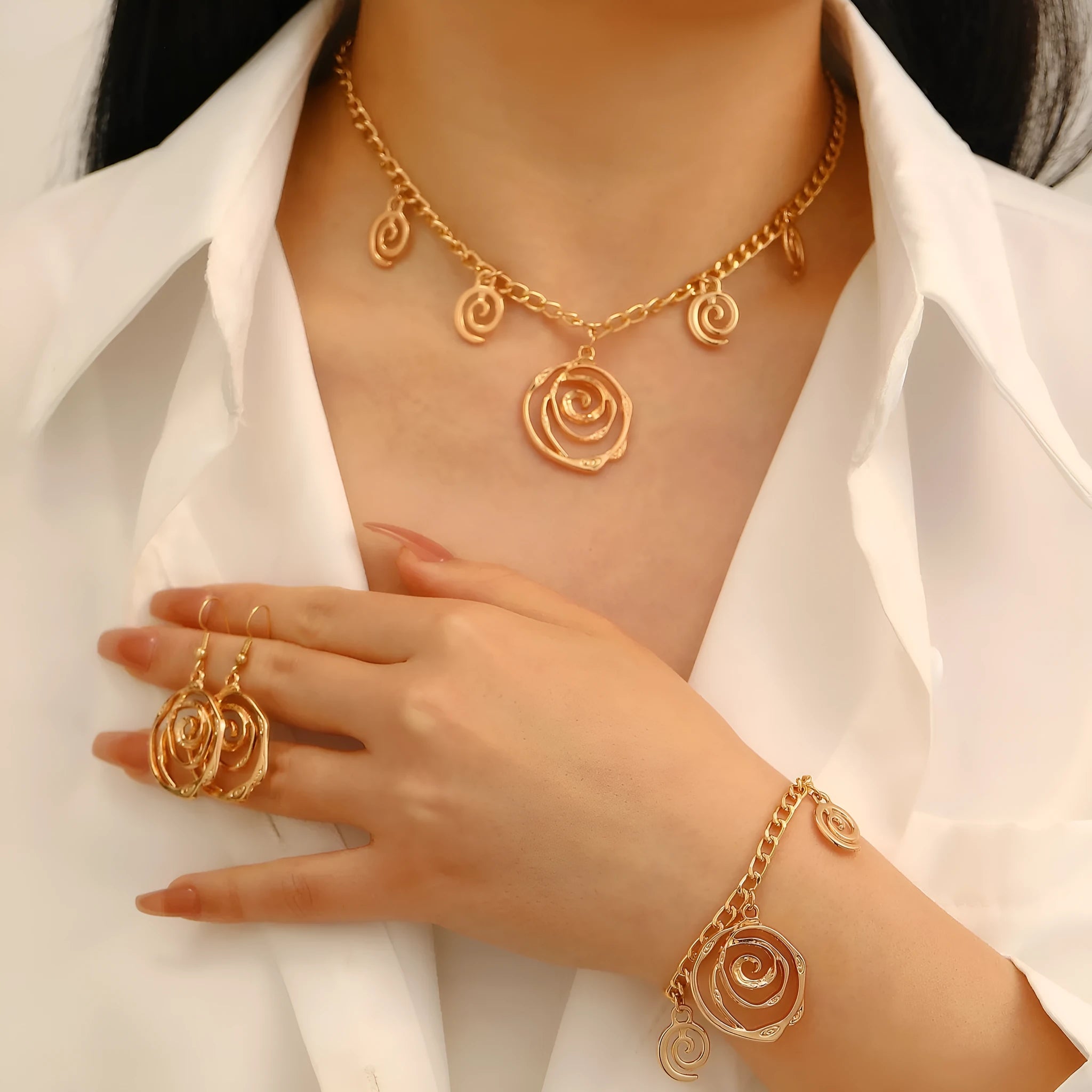 Spiral donut alloy jewellery set with necklace, bracelet, and earrings in gold or silver electroplated finish