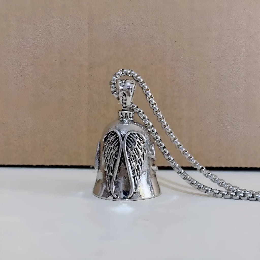 Vintage white angel feather alloy keychain and necklace on a dark background.