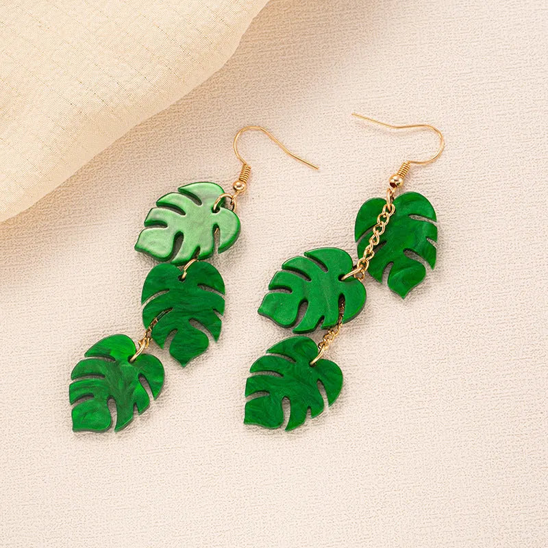 Acrylic drop-shaped earrings with coconut leaf pattern in one of five colours on an alloy hook.