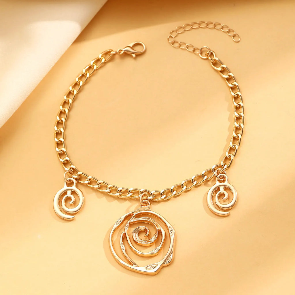 Spiral donut alloy jewellery set with necklace, bracelet, and earrings in gold or silver electroplated finish