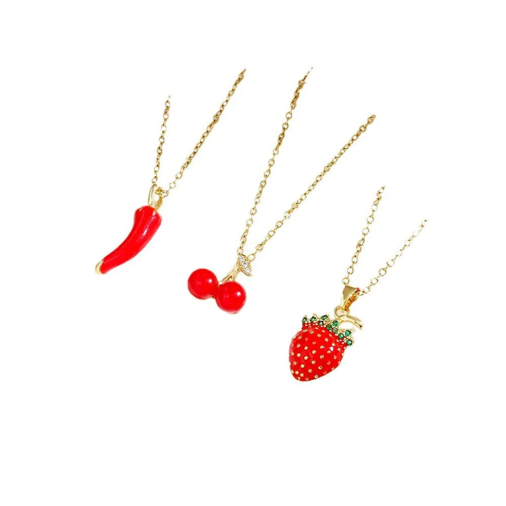 Titanium steel delicate necklace with indie cherry, strawberry, and pepper charms on an O-ring chain, shown in golden and steel colour variations.