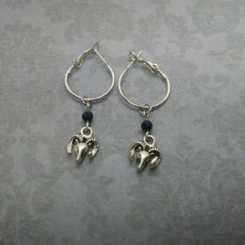 Silver alloy round hoop earrings with a Tibetan antelope design detail.