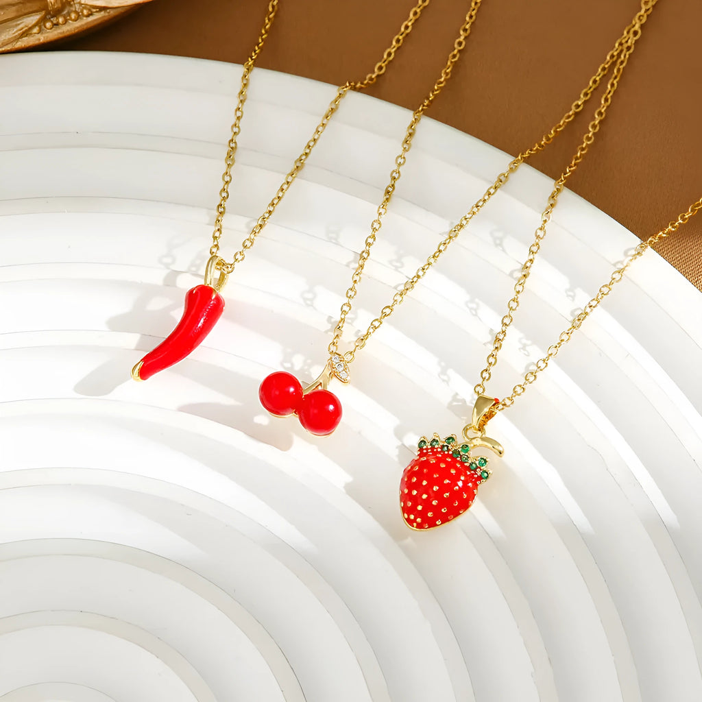 Titanium steel delicate necklace with indie cherry, strawberry, and pepper charms on an O-ring chain, shown in golden and steel colour variations.