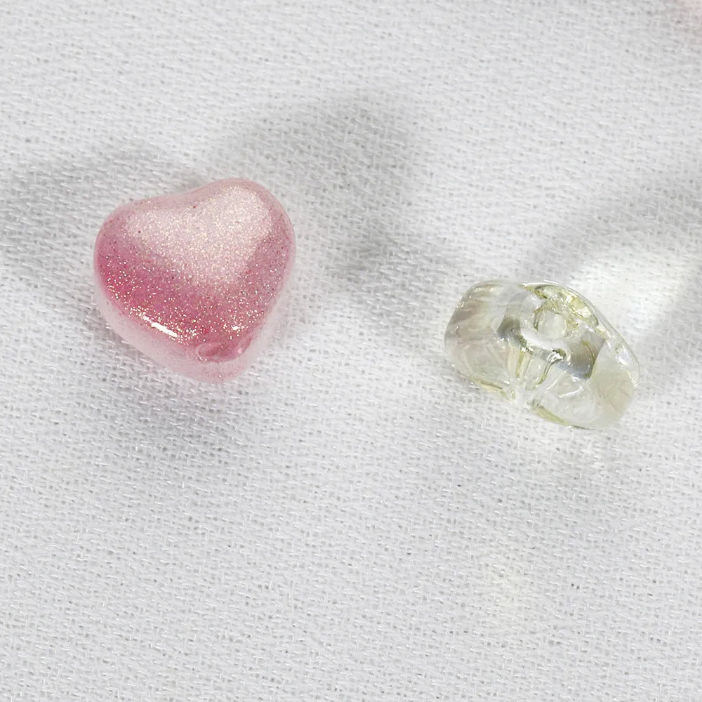20 heart-patterned Czech beads in aurora colours including purple, blue rose, and white