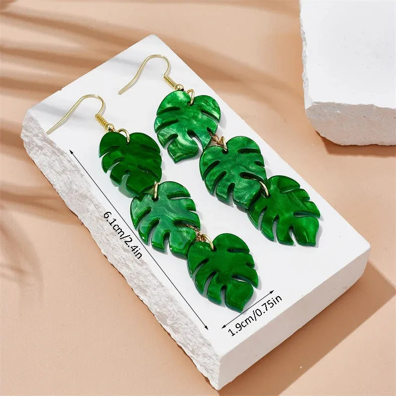Acrylic drop-shaped earrings with coconut leaf pattern in one of five colours on an alloy hook.