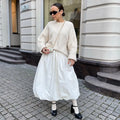 Women's solid colour cotton long skirt shown in black and white options