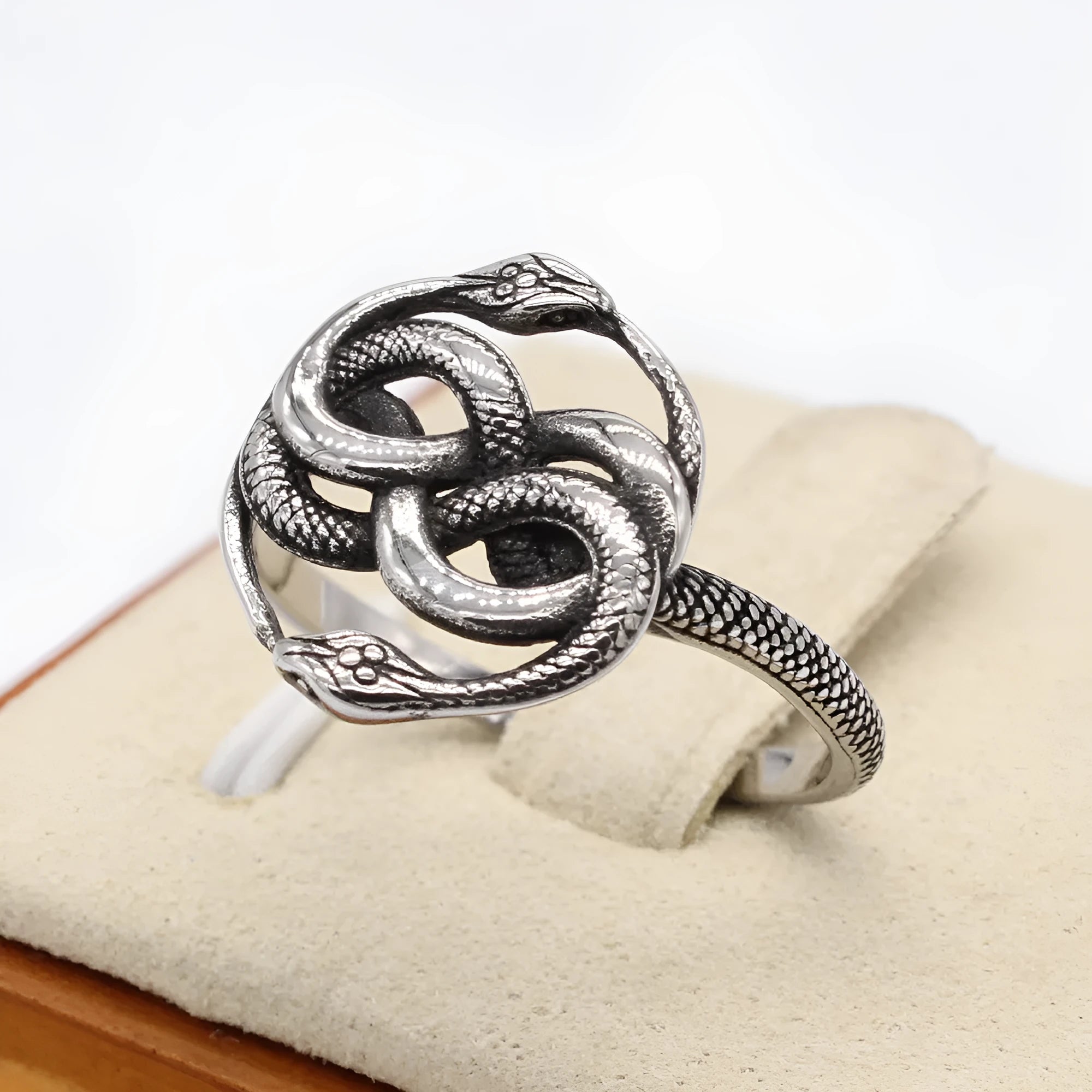 Detailed view of a titanium steel retro double snake ring in steel colour on a finger