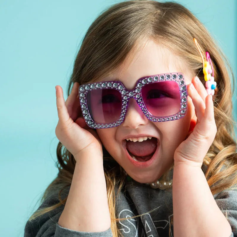 Plastic fashion sunglasses in various colour and lens combinations on a plain background.