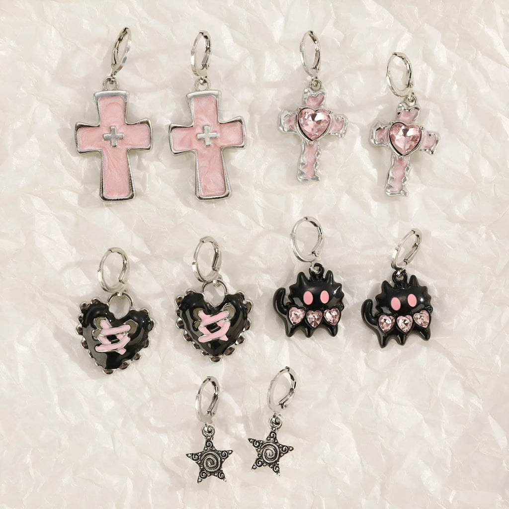 Women's classic alloy earrings with crystal detailing showing cross, heart, and cat designs in neutral white and silver colours