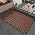 Square American wood grain patterned diatom ooze bathroom floor mat on a tiled floor.