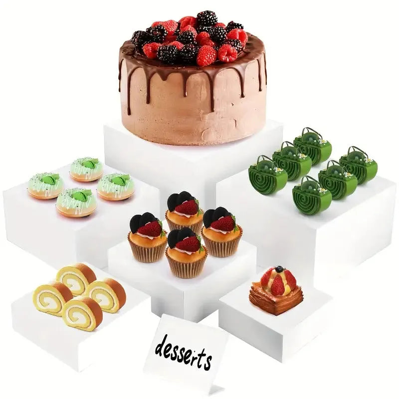 White plastic modular dessert display stand with six stackable suit cube racks on a table.