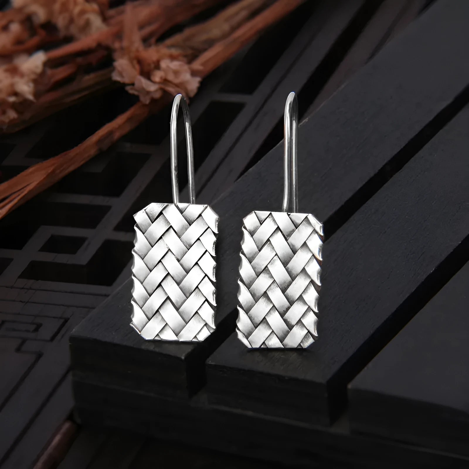 Silver geometric plaid pattern drop earrings with woven diamond design