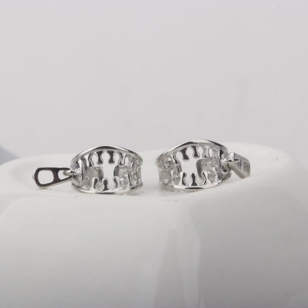 A pair of geometric copper clip-on earrings with linear design details and a zipper ear clip fastening.