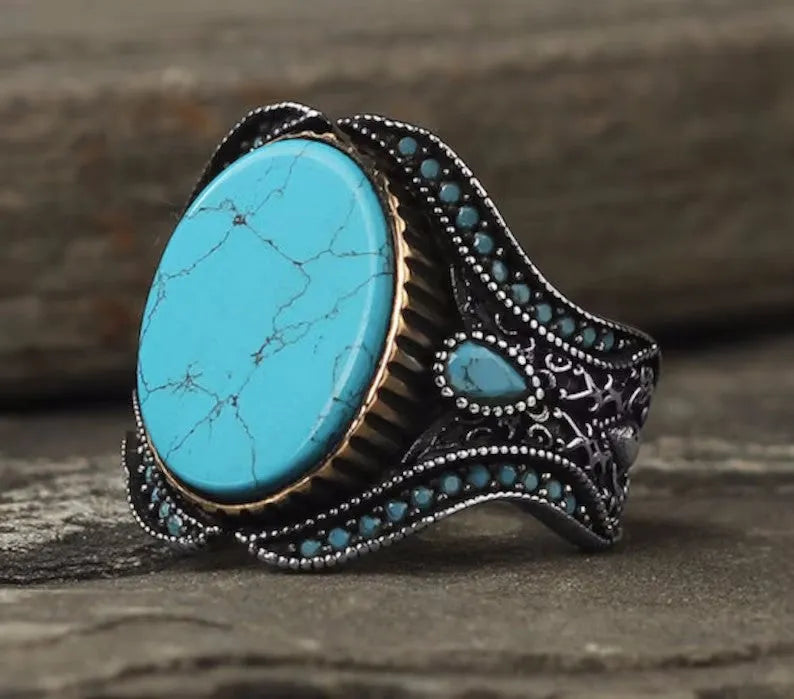 Men's turquoise round ring with antique silver finish shown in UK size 10