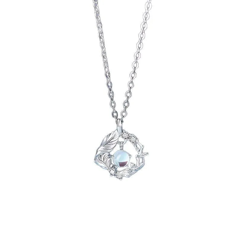 Geometric alloy pendant necklace showing a tree and bird silhouette on an adjustable chain.