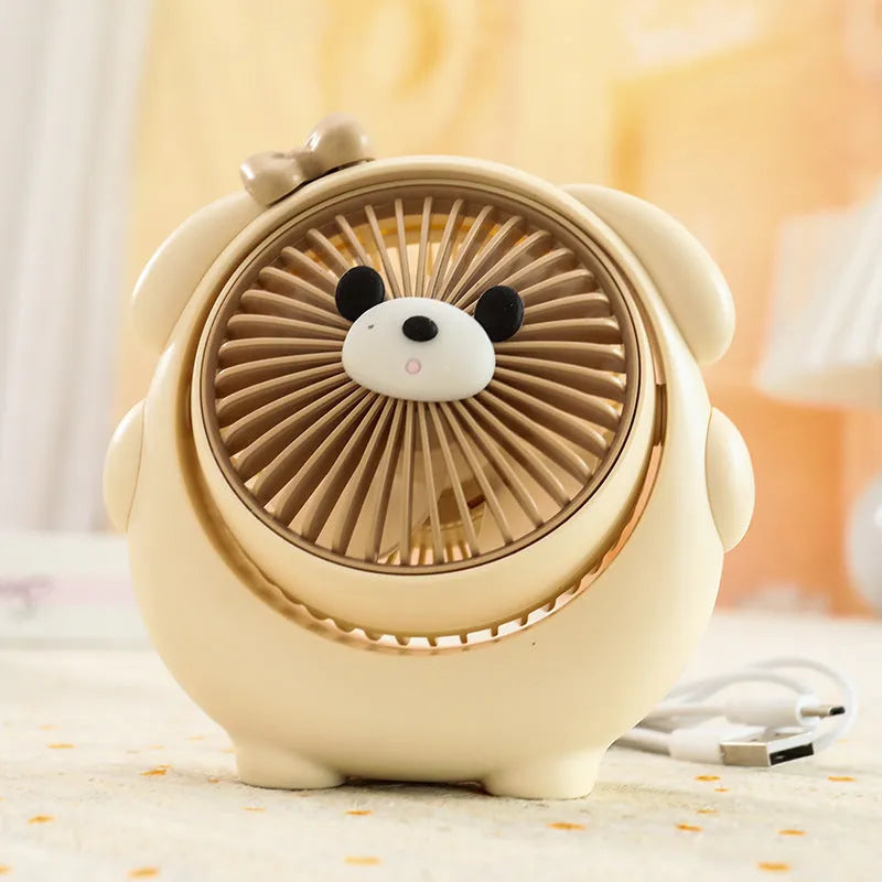USB-powered desktop electric fan in a puppy-themed colour on a desk.