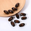 Dark coffee coloured oval wooden bead with M-shaped texture, shown next to a ruler showing 25mm size.