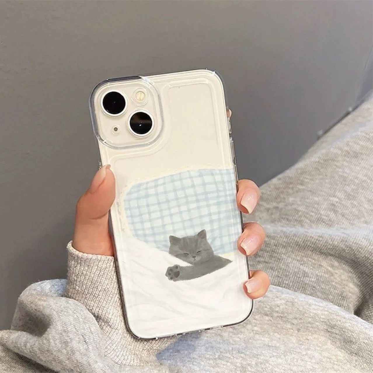 Transparent iPhone case with sleeping cat pattern showing shockproof TPU construction