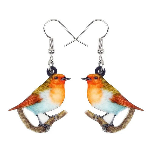 Acrylic blue titmouse bird and snake design pendant earrings on a white background.