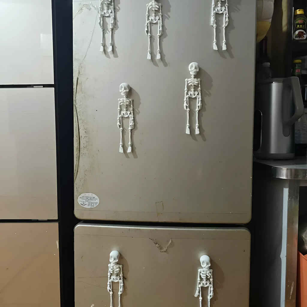3D-printed white skull refrigerator magnet, 18cm tall, on a fridge door.