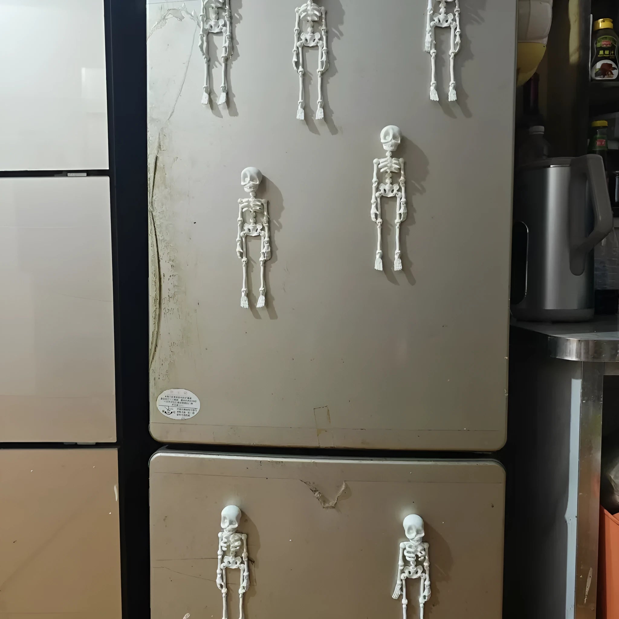 3D-printed white skull refrigerator magnet, 18cm tall, on a fridge door.