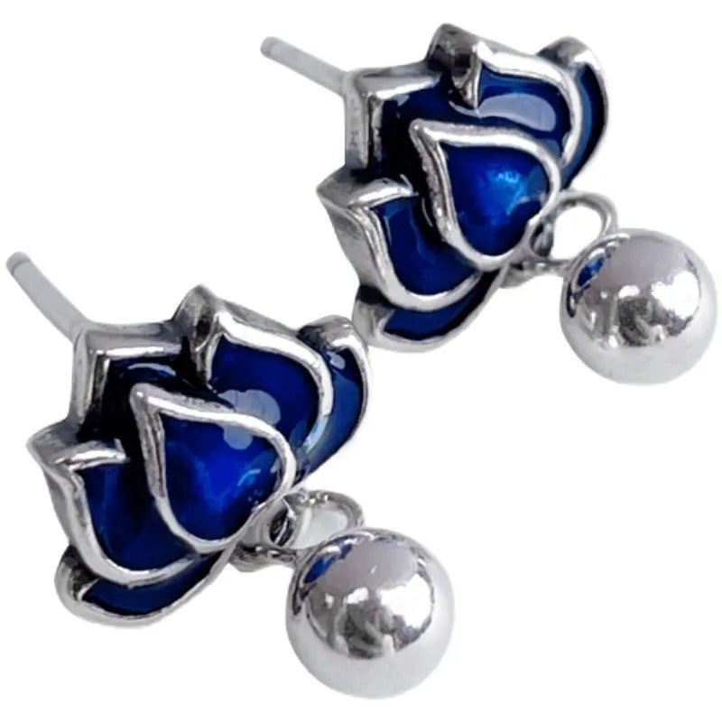 Blue alloy lotus flower ear studs with a seedpod tassel on silver posts.