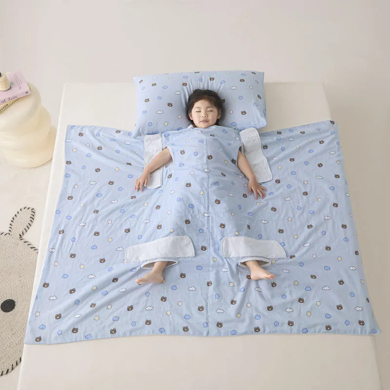 Anti-kick sleeping bag style blanket in a colourful pattern on a bed.