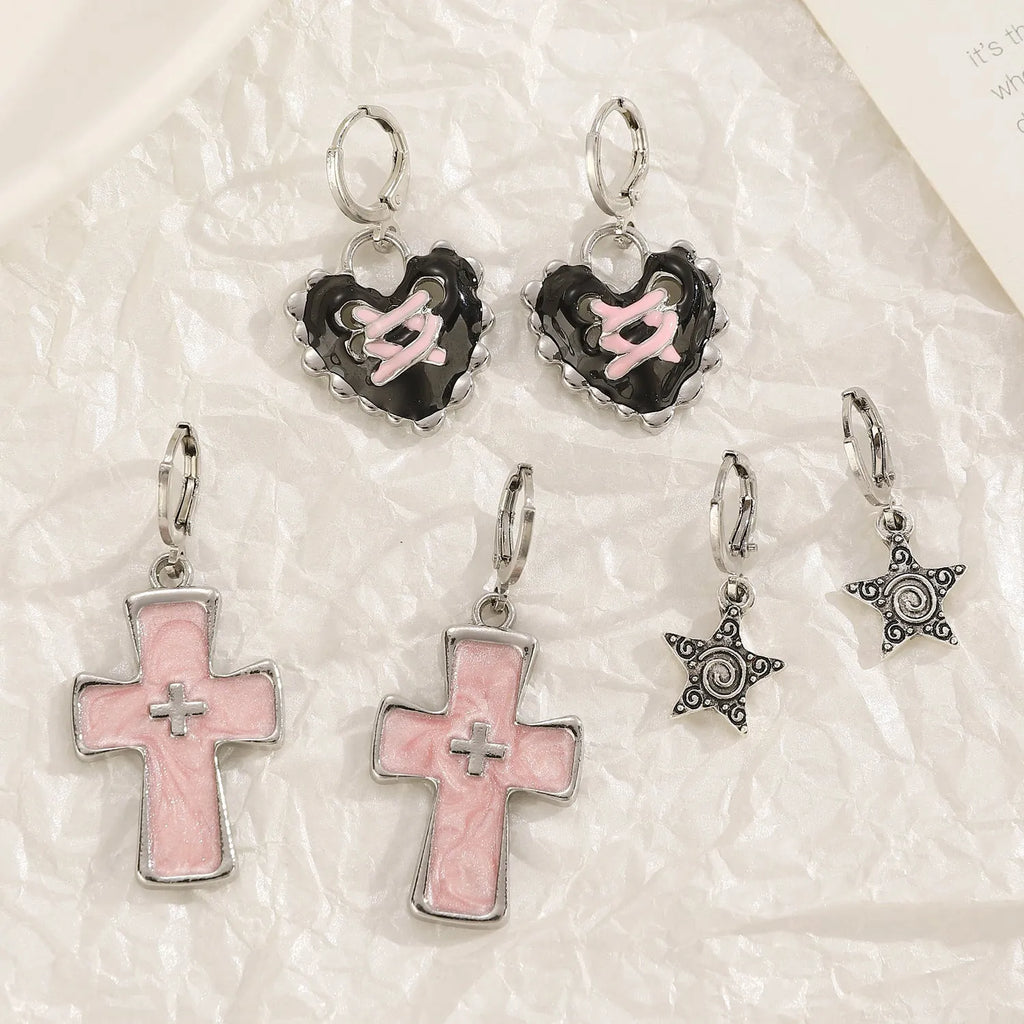 Women's classic alloy earrings with crystal detailing showing cross, heart, and cat designs in neutral white and silver colours