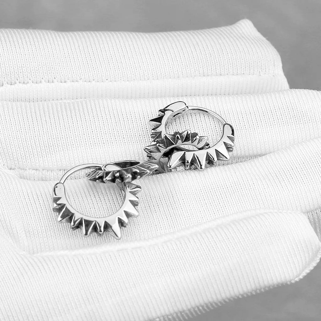 Stainless steel round hoop earrings with polished steel finish and retro design