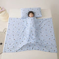 Anti-kick sleeping bag style blanket in a colourful pattern on a bed.
