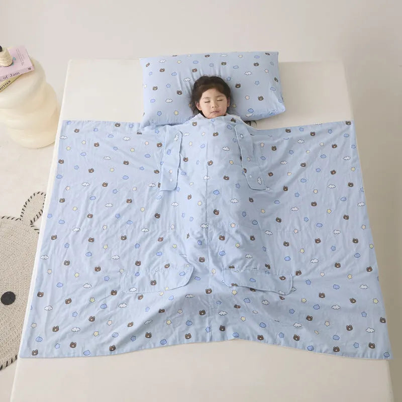 Anti-kick sleeping bag style blanket in a colourful pattern on a bed.