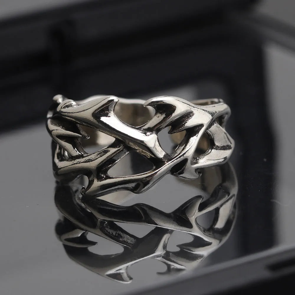 Copper adjustable ring with geometric thorn and flower design in J2150 colour on a hand.