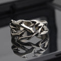 Copper adjustable ring with geometric thorn and flower design in J2150 colour on a hand.