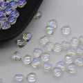 20 heart-patterned Czech beads in aurora colours including purple, blue rose, and white