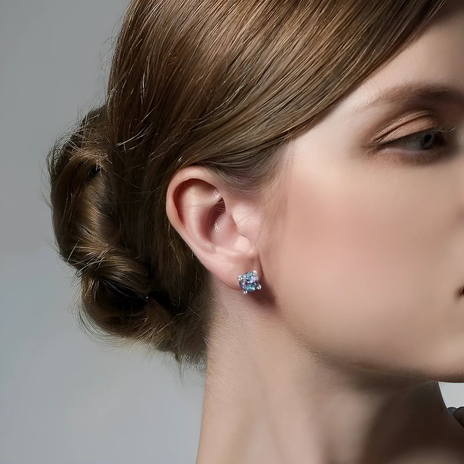 A pair of simple geometric 925 silver ear studs with round cultivated alexandrite stones.