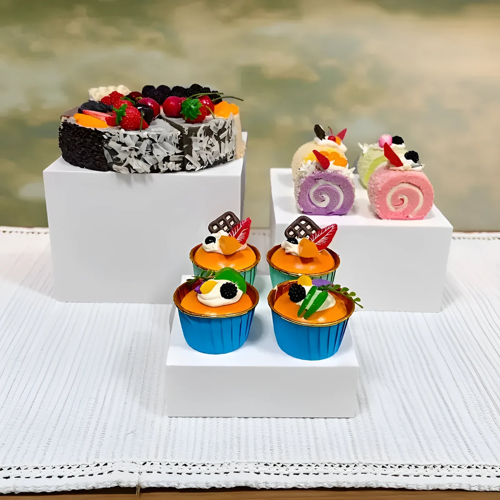 White plastic modular dessert display stand with six stackable suit cube racks on a table.